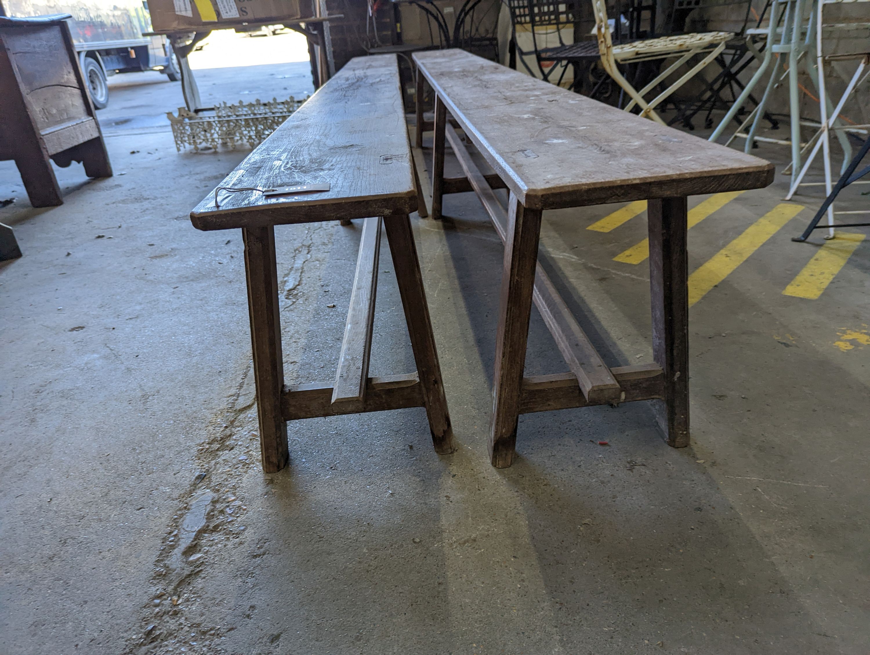 A pair of 19th century French provincial oak long bench seats, length 300cm, depth 24cm, height 45cm